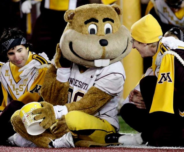 Minnesota mascot Goldie Gopher, center, performs with members of the marching band during the second half of a NCAA college football game, Saturday Oct. 30, 2010 in Minneapolis. Ohio State won 52-10. (AP Photo/Paul Battaglia)