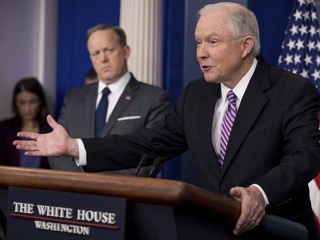Attorney General Jeff Sessions, right, accompanied by White House press secretary Sean Spicer, talks to the media during the daily press briefing at the White House in Washington, Monday, March 27, 2017. (AP Photo/Andrew Harnik)