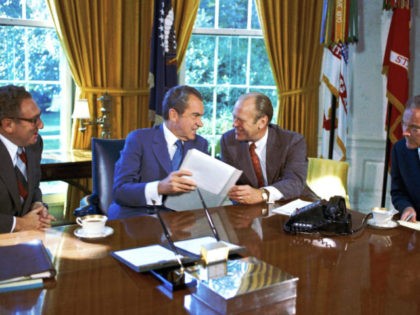 From left: Henry Kissinger, President Richard Nixon, Vice President Gerald Ford are pictured in Washington in an undated photo. Man at right unidentified. (AP Photo)