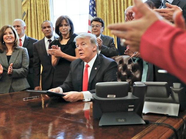 Small business leaders applaud President Donald Trump after he signed an executive order i