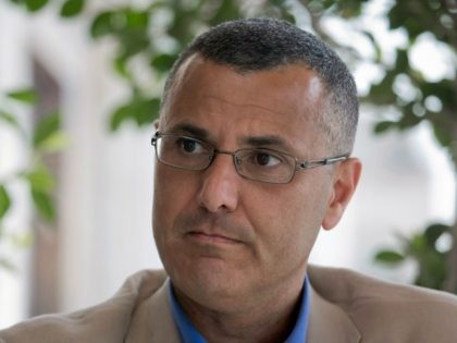 Omar Barghouti listens during an interview with the Associated Press in the West Bank city