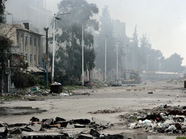 In this photo released by the Syrian official news agency SANA, damaged and blocked street where clashes erupted between the Syrian government forces and rebels, near the Abbassiyin square, east Damascus, Syria, Monday March 20, 2017. Syrian government forces on Monday regained control of parts of Damascus that were attacked …