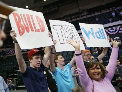 TAMPA, FL - FEBRUARY 12: People hold signs that read, ' Build that Wall', as they wait for the start of a campaign rally for Republican presidential candidate Donald Trump at the University of South Florida Sun Dome on February 12, 2016 in Tampa, Florida. The process to select the …