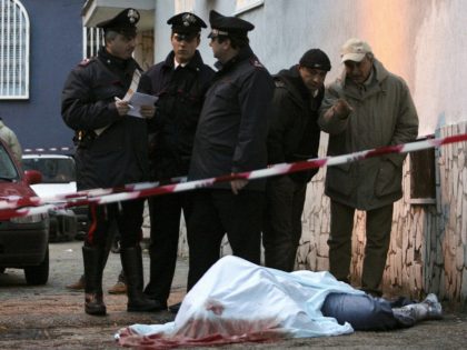 NAPLES, ITALY: Italian policemen examine the body of Emanuele Leoni, …