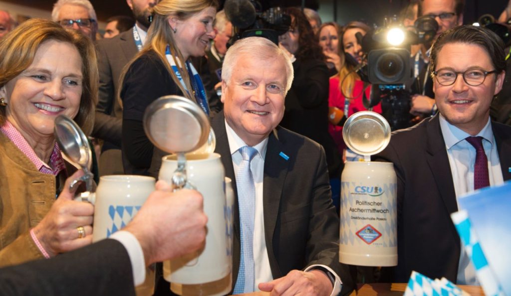 Bavarian State Premier and head of German Christian Social Union (CSU) Horst Seehofer (C), his wife Karin Seehofer (L) and the secretary general of the CSU Andreas Scheuer, hold up their beer mugs at the party's traditional Ash Wednesday rally in Passau, southern Germany, on March 1, 2017. During the traditional "political Ash Wednesday" German politicians let rip at their rivals and deliver acerbic speeches at beer-fuelled events on Ash Wednesday, which also marks the end of carnival. / AFP / THOMAS KIENZLE (Photo credit should read THOMAS KIENZLE/AFP/Getty Images)