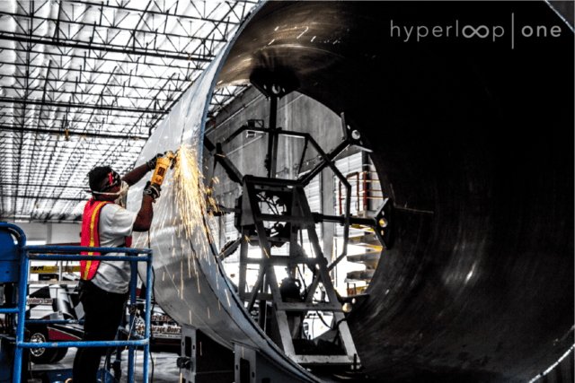 Grinding a fresh cut on one of Hyperloop's tubes at tMheir etalworks tooling shop in North Las Vegas.