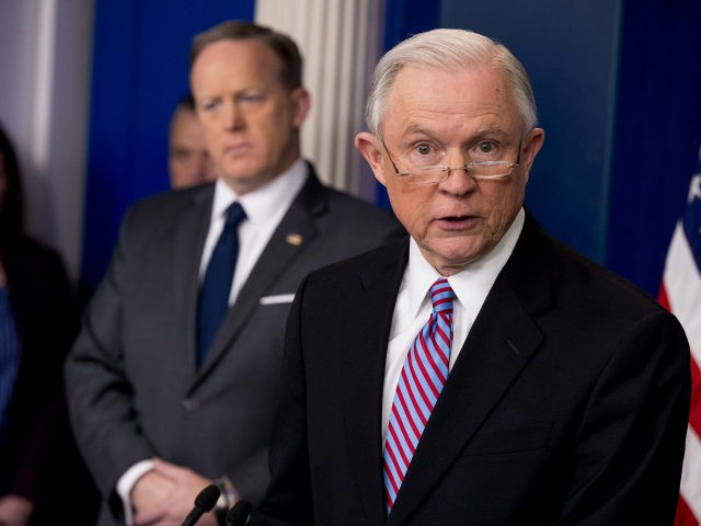 Attorney General Jeff Sessions, right, accompanied by White House press secretary Sean Spicer, second from right, talks to the media during the daily press briefing at the White House, Monday, March 27, 2017, in Washington. (AP Photo/Andrew Harnik)