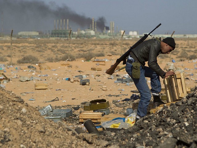 A Libyan rebel volunteer near the wealthy oil town of Ras Lanuf, looking for ammunition am