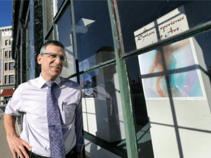 In this Nov. 14, 2016 photo, Mayor Chris Louras poses outside an exhibit featuring Syrian