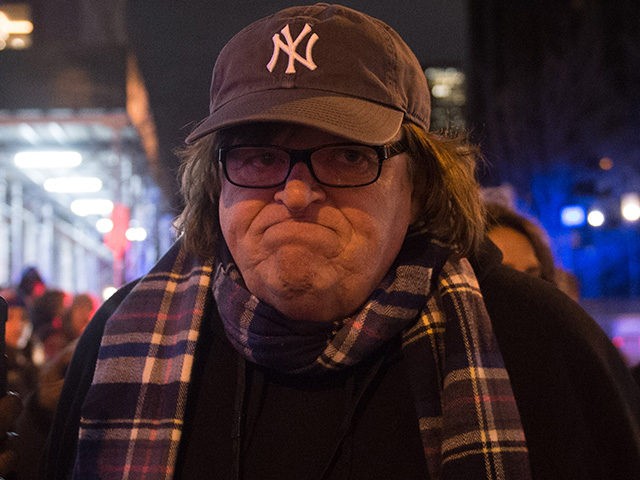 Michael Moore with supporters walks with the 'We Stand United' rally on the eve of US President-elect Donald Trump's inauguration outside Trump International Hotel and Tower in New York on January 19, 2017 in New York. / AFP / Bryan R. Smith (Photo credit should read BRYAN R. SMITH/AFP/Getty Images)