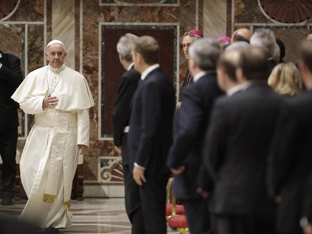 Pope Francis (L) arrives for an audience to European Union leaders at the Vatican, on Marc