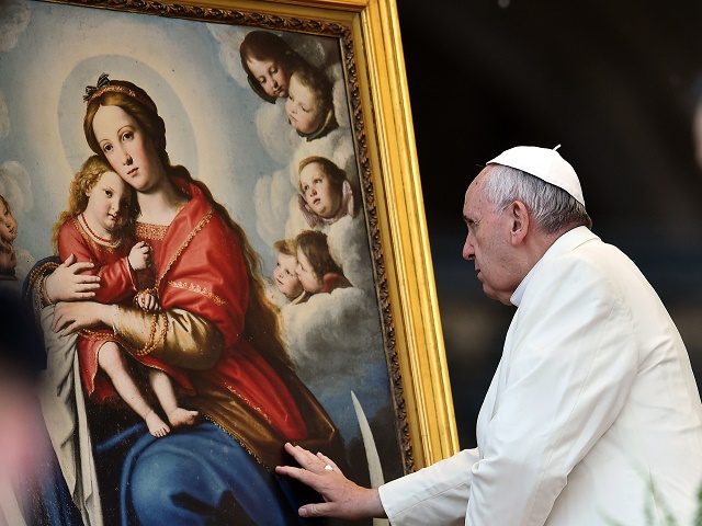 Pope Francis touches a painting depicting Virgin Mary at the end of his weekly general audience in St Peter's square at the Vatican on March 25, 2015. AFP PHOTO / GABRIEL BOUYS (Photo credit should read GABRIEL BOUYS/AFP/Getty Images)