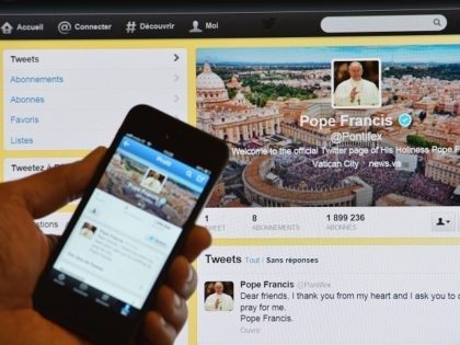 A man holds a smartphone showing Pope Francis' first tweet in front of a computer screen showing the same tweet on March 17, 2013 in Rome. Pope Francis issued his first tweet on Sunday shortly after performing his first Angelus prayer, with a consistent message: "Pray for me". "Dear friends, …