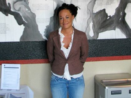 In this July 24, 2009, file photo, Rachel Dolezal, a leader of the Human Rights Education Institute, stands in front of a mural she painted at the institute's offices in Coeur d'Alene, Idaho. Dolezal, the former NAACP chapter president who made headlines in 2015 when her race came into question, …