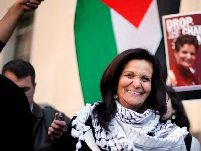 Rasmea Odeh smiles after leaving federal court in Detroit Thursday, March 12, 2015. A judge sentenced the Chicago activist to 18 months in federal prison Thursday for failing to disclose her convictions for bombings in Israel when she applied to be a U.S. citizen. Odeh, 67, also was stripped of …