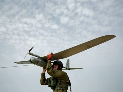 In this Sunday, March 16, 2014 photo, An Israeli soldier prepares to launch a Skylark drone for a reconnaissance mission over the Hamas held Gaza Strip, near the Israel and Gaza border. (AP Photo/Tsafrir Abayov)