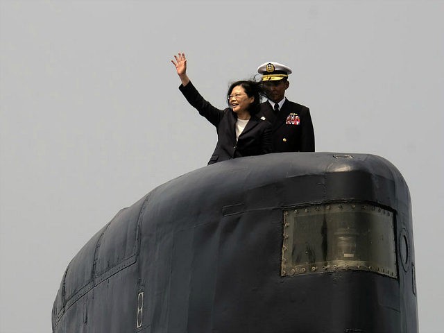 Taiwan President Tsai Ing-wen waves from a Duch-made Sea Tiger submarine at the Tsoying navy base in Kaohsiung, southern Taiwan on March 21, 2017. Taiwan formally launched an ambitious project to build its own submarines as the island faces growing military threats from China as relations deteriorate. / AFP PHOTO …