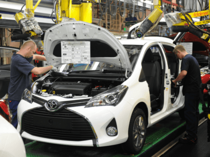 Employees are at work on the assembly line of the Toyota Yaris, on June 30, 2015 at the Toyota plant in Onnaing, northern France.