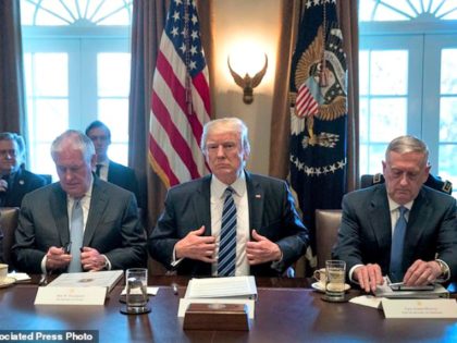 President Donald Trump, center, accompanied by Secretary of State Rex Tillerson, left, and Defense Secretary Jim Mattis, right, meets with members of his Cabinet in the Cabinet Room at the White House, Monday, March 13, 2017, in Washington. (AP Photo/Andrew Harnik)
