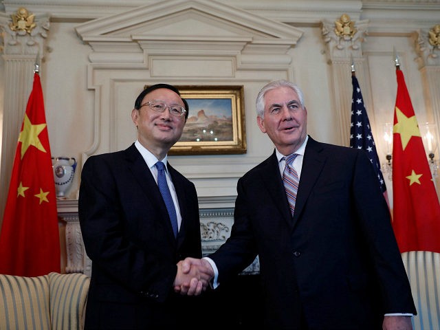 Secretary of State Rex Tillerson greets Chinese State Councilor Yang Jiechi at the State D