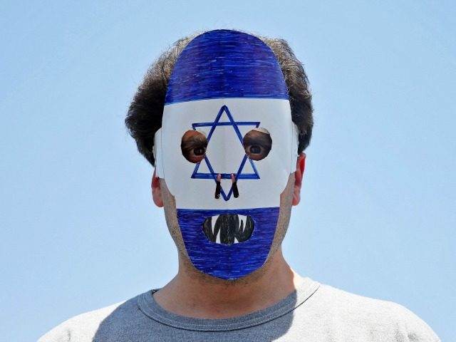 An Iranian demonstrator wears an anti Israeli mask during an annual pro-Palestinian rally