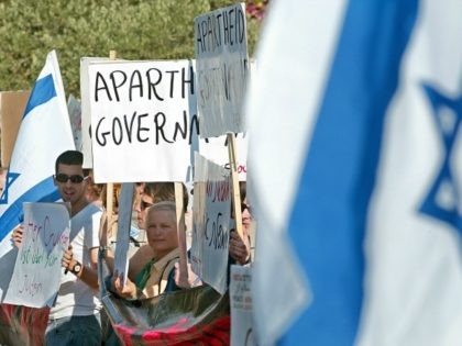 Israelis hold signs as they demonstrate against what they call an 'Apartheid Governme