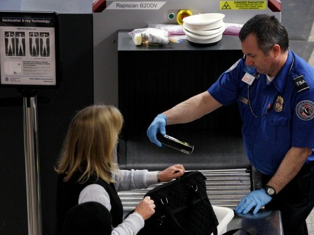 A TSA officer looks over a canister in the carry-on bag of a passenger at a security check-point Monday, Nov. 22, 2010, at Seatttle-Tacoma International Airport in Seattle. With the Thanksgiving holiday travel gearing up, the White House said Monday the government will take into account the public's concerns and …