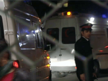 Seen through the hospital gates, an ambulance is escorted, believed to be carrying the bodies of two western journalists, Marie Colvin and Remi Ochlik, arriving late Friday March 2, 2012, to Alassad University Hospital in Damascus, Syria, after having been delivered earlier Friday by Syrian authorities to the International Committee …