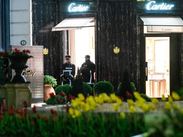Monaco's police officers stand guard in front of the Cartier jewellery boutique after