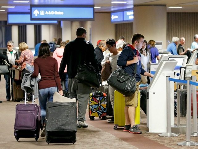 Thanksgiving holiday travelers check in at Phoenix Sky Harbor Airport Wednesday, Nov. 23, 2016, in Phoenix. (AP Photo/Ross D. Franklin)
