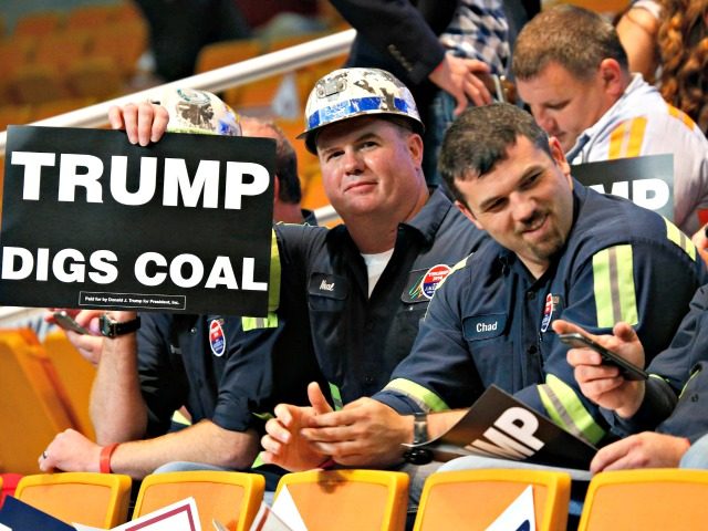 A group of coal miners hold Trump signs as they wait for a rally in Charleston, W.Va., Thursday, May 5, 2016. (AP Photo/Steve Helber)