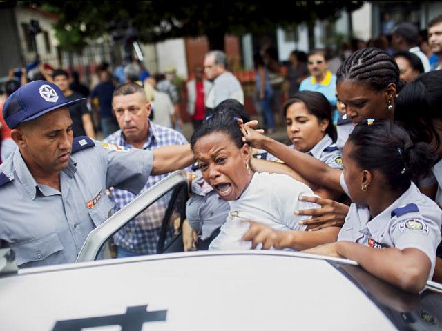 Cuban security personnel detain a member of the Ladies in White dissident group during a protest on International Human Rights Day, Havana, December 10. Cuban police detained at least six protesters shouting "Freedom" and "Long live human rights" in Havana on Thursday and dissidents reported 100 arrests nationwide on U.N. …