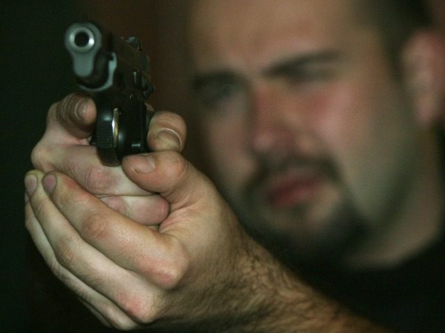 An unidentified sports shooter aims a Czech made CZ 9mm gun on a target at the shooting ra