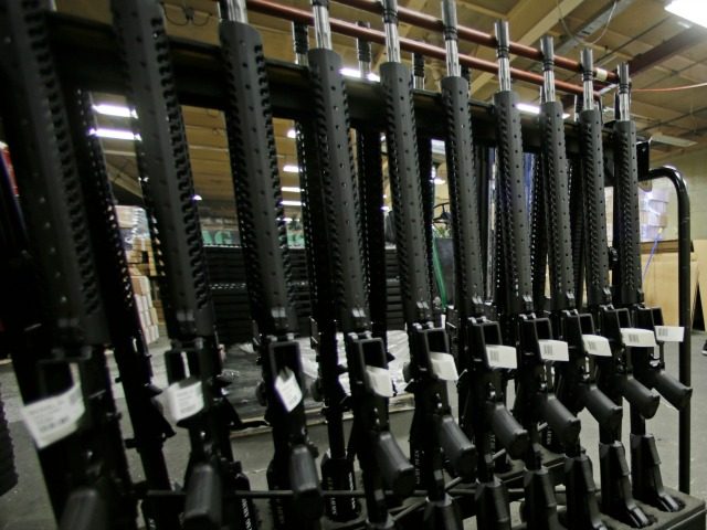 In this April 10, 2013 file photo, newly made AR-15 rifles stand in a rack at Stag Arms in