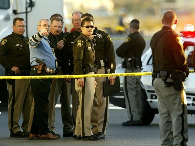Police are seen, Wednesday, Feb. 1, 2006, at the scene where a Las Vegas police officer wa