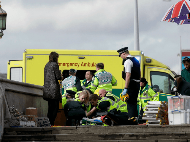 Emergency services staff provide medical attention close to the Houses of Parliament in London, Wednesday, March 22, 2017. London police say they are treating a gun and knife incident at Britain's Parliament "as a terrorist incident until we know otherwise." Officials say a man with a knife attacked a police …