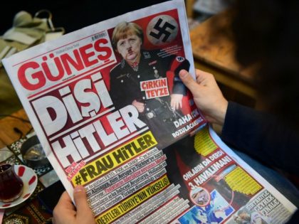 A man reads an issue of Gunes, a Turkish pro-government daily newspaper, with on its front page German Chancellor Angela Merkel depicted in Nazi uniform with a Hitler-style moustache, labelling the German leader 'She Hitler', on March 17, 2017 in Istanbul, Turkey. Right-wing tabloid-style daily Gunes ('Sun') printed the picture …