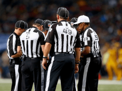 Referees discuss a call in the second quarter of a football game -- the NFL will test a new rule in 2016 under which players will be ejected from games if they receive two unsportsmanlike conduct penalties