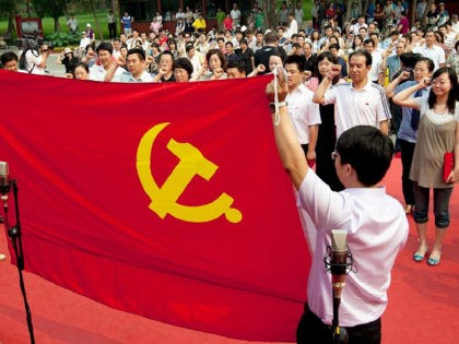 Participants at an event celebrating the 90th anniversary of the Chinese Communist Party salute the Communist Party flag in Beijing, China, on Tuesday, June 28, 2011. China's Communist Party celebrates its 90th anniversary on July 1. Photographer: Nelson Ching/Bloomberg via Getty Images