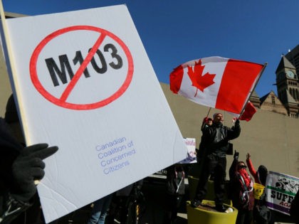 Opponents of the anti-Islamophobia federal government motion M-103 wave Canadian flags dur