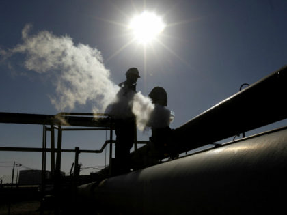 FILE - In this Feb. 26, 2011, file photo, a Libyan man works at a refinery inside the Breg