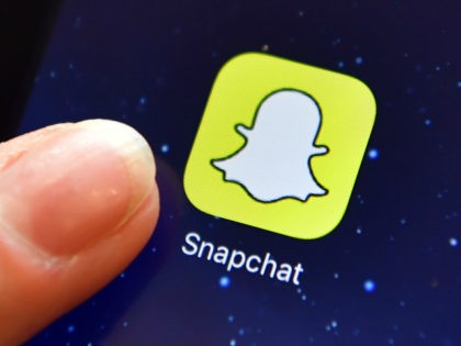 LONDON, ENGLAND - AUGUST 03: A finger is posed next to the Snapchat app logo on an iPad on August 3, 2016 in London, England. (Photo by Carl Court/Getty Images)