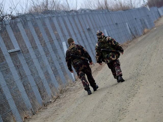 Border soldiers patrol along the border fence on the Hungarian-Serbian border near the village of Roszke on February 24, 2017. The Hungarian defence forces have been performing construction and security tasks along the whole length of the more than 300-km-long temporary security barrier since July 2015. Several thousand soldiers patrol …
