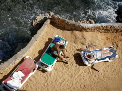 ourists sunbathe on the shore of the Red Sea at a hotel that is hosting many travelers waiting to be evacuated from the resort city of Sharm el-Sheikh, south Sinai, Egypt, Saturday, Nov. 7, 2015. Russia has suspended all flights to Egypt, joining the U.K., which had specifically banned all …
