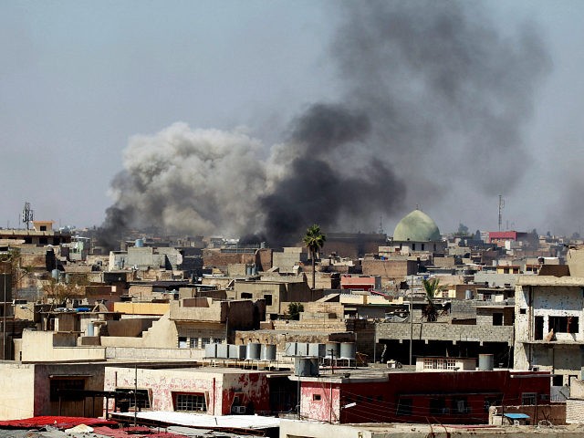 Smoke rises over the city during clashes between Iraqi forces and Islamic State militants,