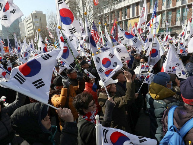Pro- President Park Guen-Hye hold the national flag near the South Korea's Constitutional