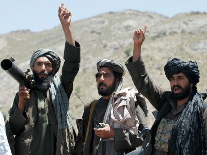 FILE - In this May 27, 2016 file photo, Taliban fighters react to a speech by their senior leader in the Shindand district of Herat province, Afghanistan. Two senior Taliban figures said that Pakistan has issued a stark warning to the militant group, apparently surprised over being excluded from the …