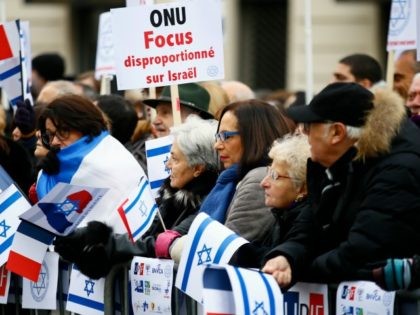 Pro-Israel demonstrators hold a placard reading "United Nations Organization Disproportionate Focus on Israel" during a gathering in front of Israel embassy in Paris, France, Sunday, Jan. 15, 2017. Fearing a new eruption of violence in the Middle East, more than 70 world diplomats gathered in Paris on Sunday to push …