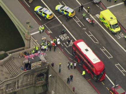 In this image taken from video emergency personnel gather around a body on the southside of Westminster Bridge that leads to the Houses of Parliament in London, Wednesday, March 22, 2017 after the House of Commons sitting was suspended as witnesses reported sounds like gunfire outside. The leader of Britain's …