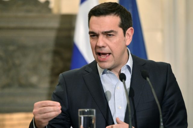 Greek Prime Minister Alexis Tsipras speaks during a press conference with his French count